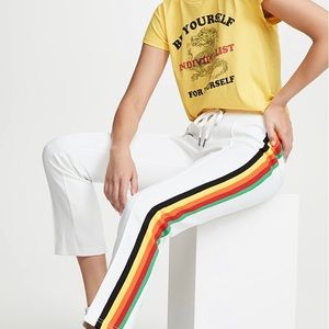 Pam & Gela cropped track pants in white with rainbow stripes and white zippers